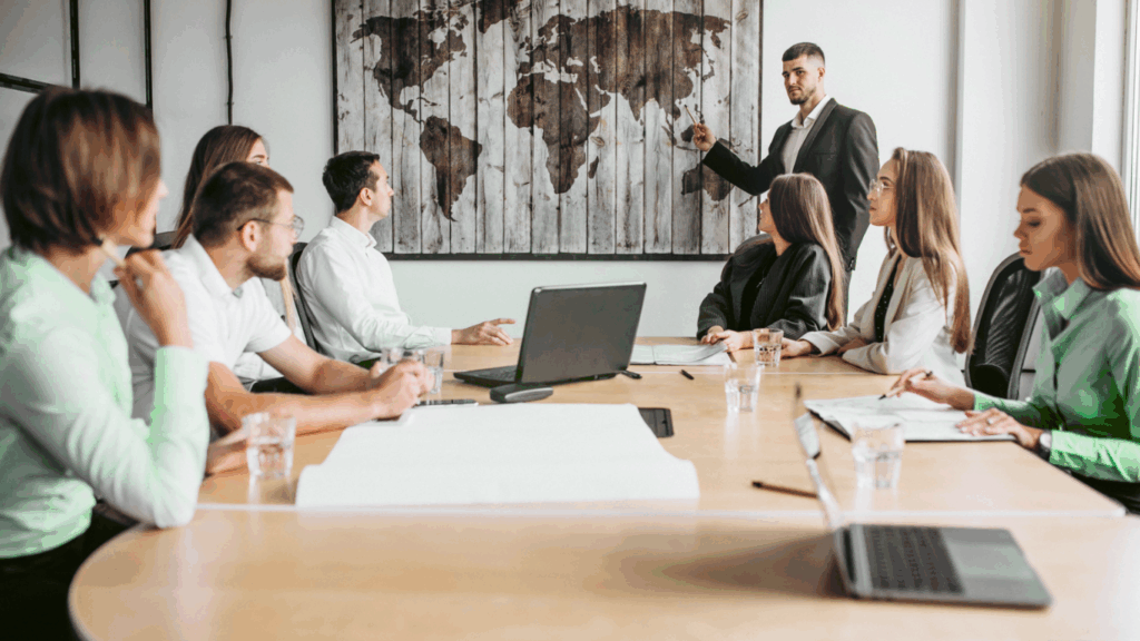 Our services team meeting in a conference room, discussing strategy and planning next steps.”